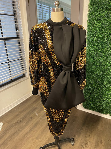 Black and gold sequin dress with oversize bow